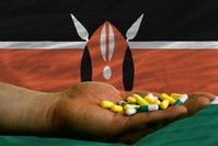 Pills, hand and Kenyan flag