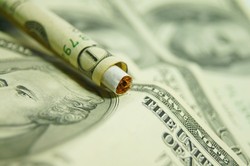 Cigarette in dollar bill Cigarette in dollar bill