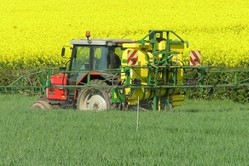 Tractor spreading pesticide
