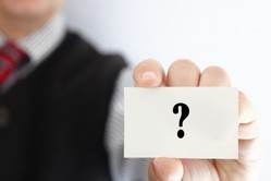 Man holding card with question mark
